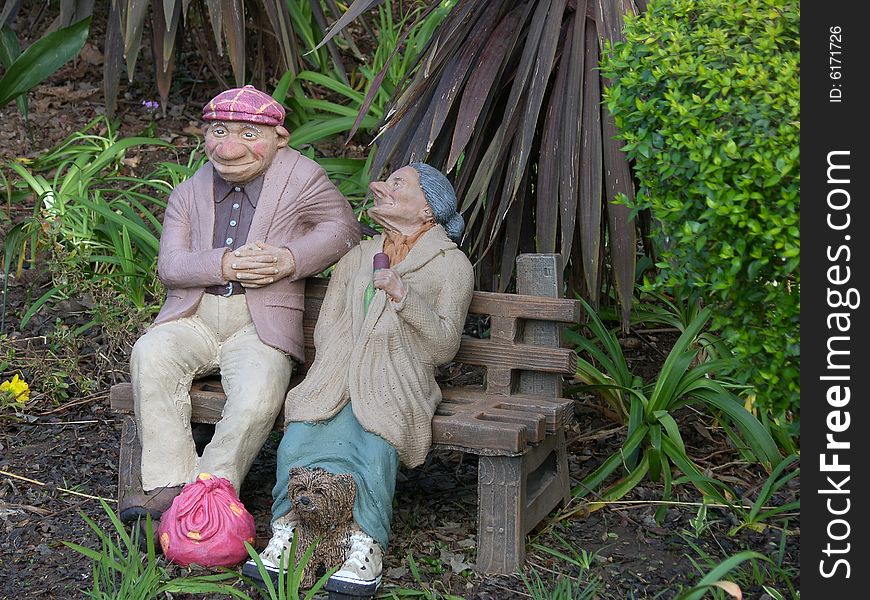 Stone garden ornament of two old tramps. Stone garden ornament of two old tramps