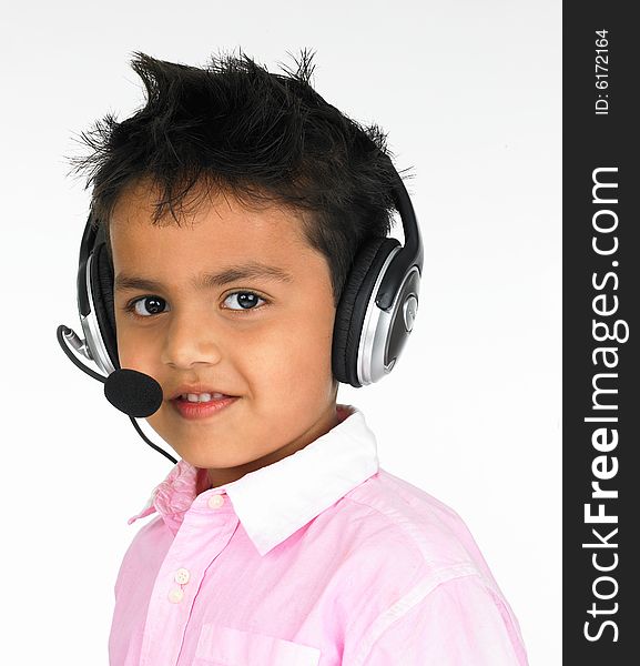 Young Indian boy sitting with headphones on a head. Young Indian boy sitting with headphones on a head