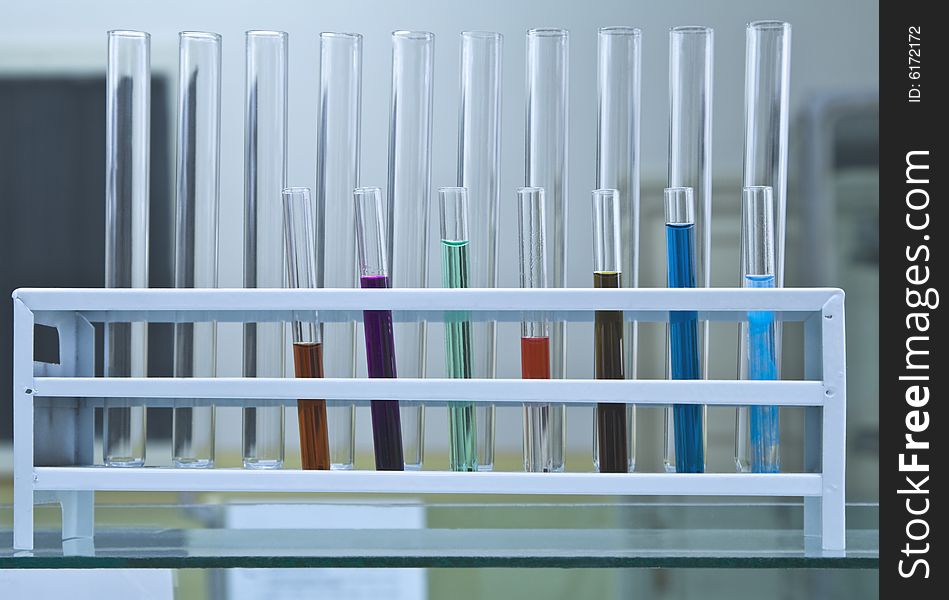 Test tubes in a rack,some of them containing colorful solutions. Test tubes in a rack,some of them containing colorful solutions.