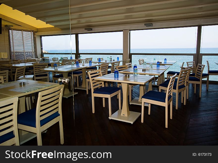 Stylish empty cafe interior on the sea beach. Stylish empty cafe interior on the sea beach