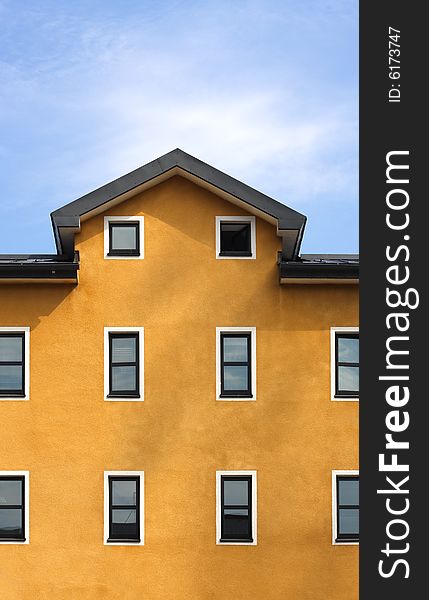 Orange Building And Blue Sky Vertical