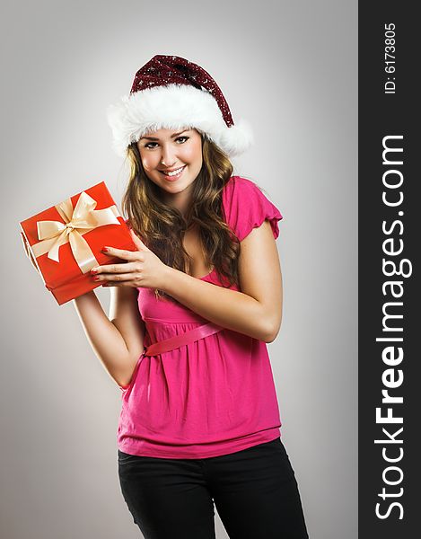 Winter portrait of a beautiful young smiling woman with a christmas cap. Winter portrait of a beautiful young smiling woman with a christmas cap