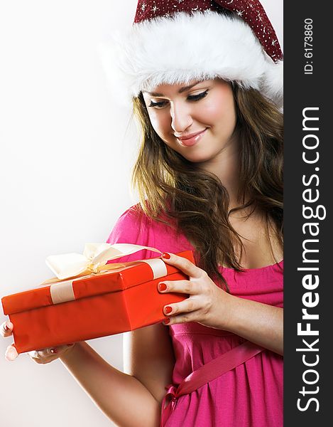 Winter portrait of a beautiful young smiling woman with a christmas cap. Winter portrait of a beautiful young smiling woman with a christmas cap