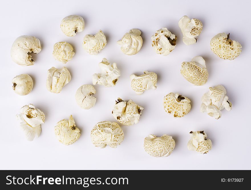 Popcorn grains spilted on white background. Popcorn grains spilted on white background