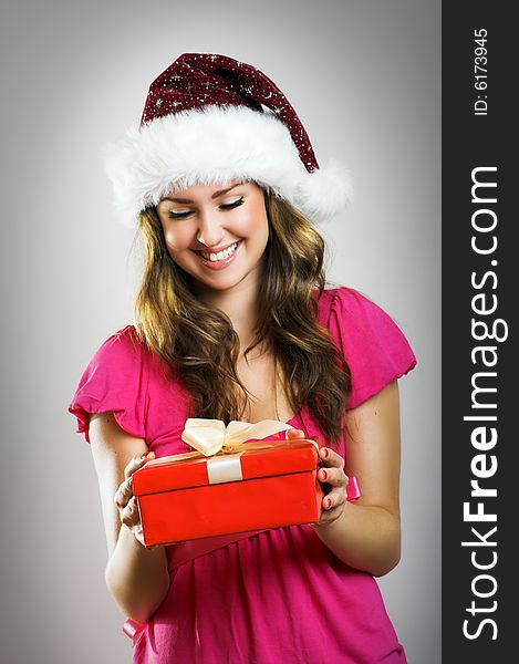 Winter portrait of a beautiful young smiling woman with a christmas cap. Winter portrait of a beautiful young smiling woman with a christmas cap