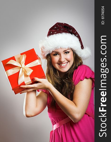 Winter portrait of a beautiful young smiling woman with a christmas cap. Winter portrait of a beautiful young smiling woman with a christmas cap