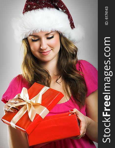 Winter portrait of a beautiful young smiling woman with a christmas cap. Winter portrait of a beautiful young smiling woman with a christmas cap