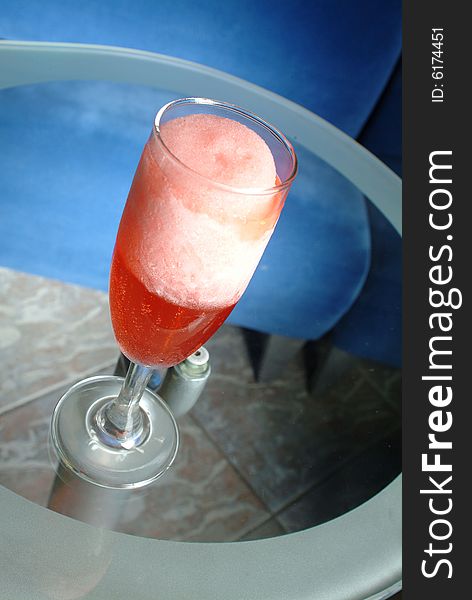 Red frappe cocktail in a glass table. Red frappe cocktail in a glass table