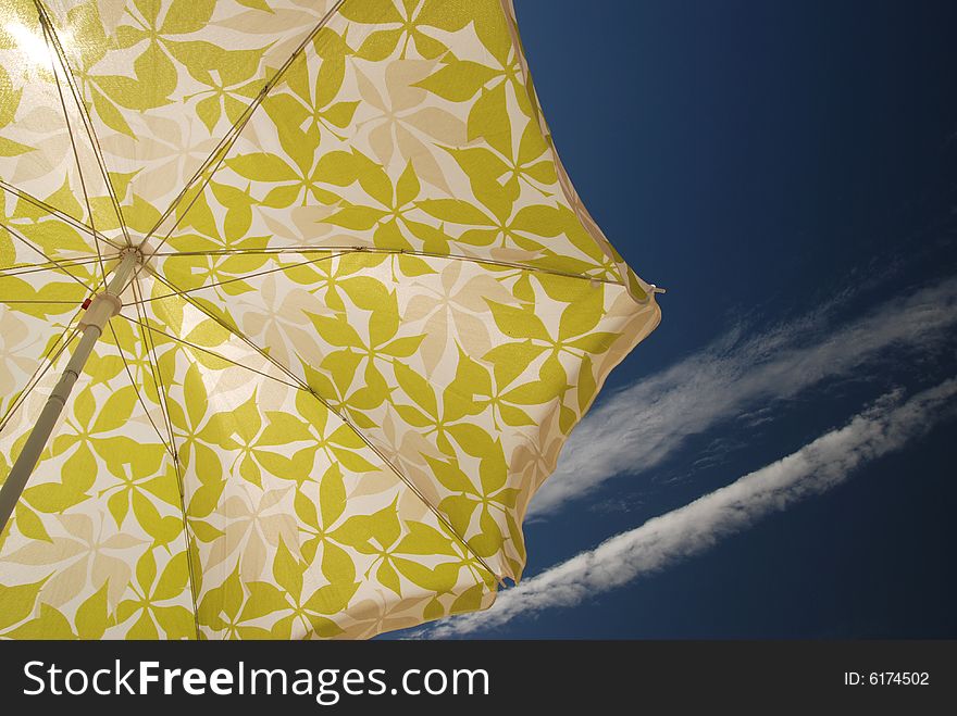 Beach umbrella and deep blue sky with clouds. Beach umbrella and deep blue sky with clouds