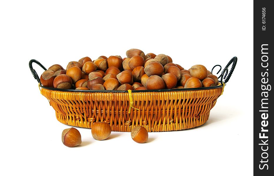 Wood nuts in a basket isolated on a white background