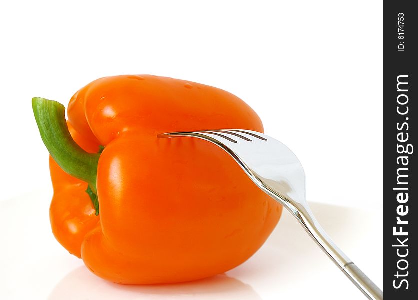 Sweet pepper and fork on a white plate