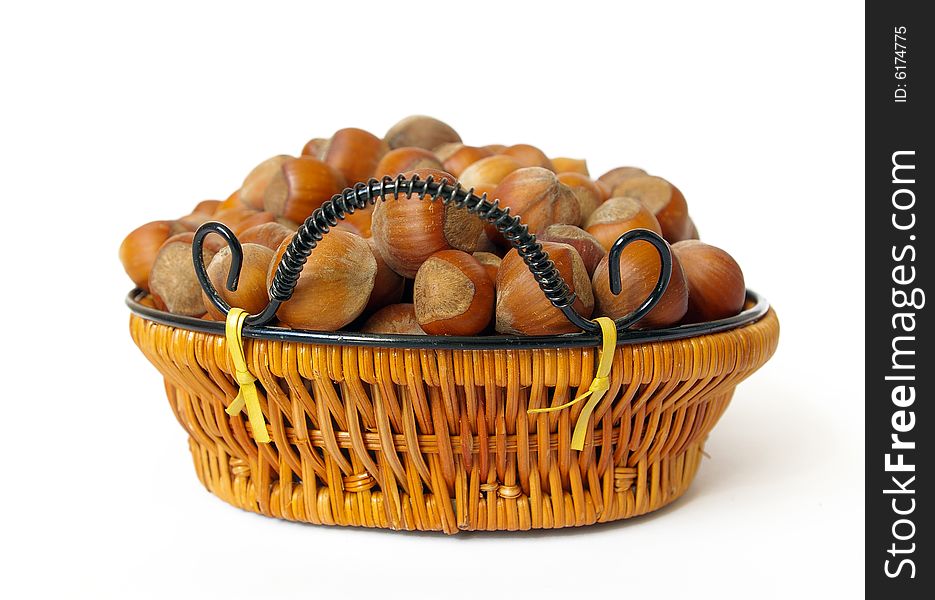 Wood nuts in a basket isolated on white