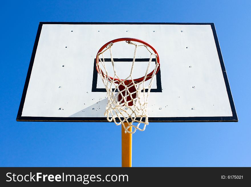 Basketball hoop with blue sky in background