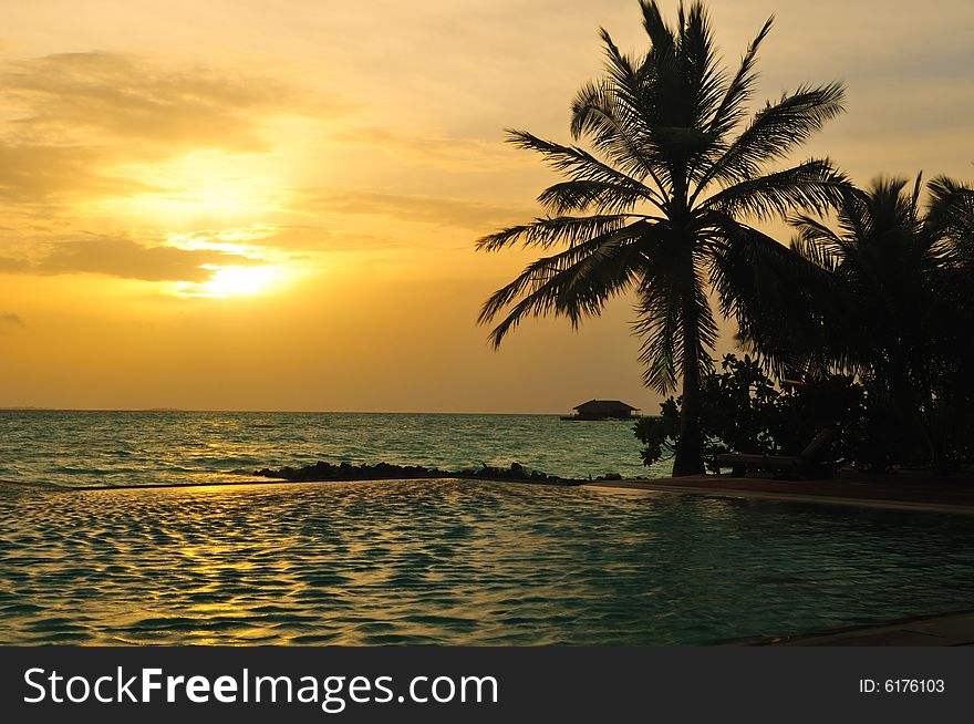 View of sunset on a tropical beach in Maldives