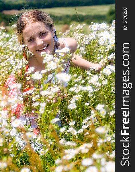 Girl surrounded by flowers. Soft focus lens