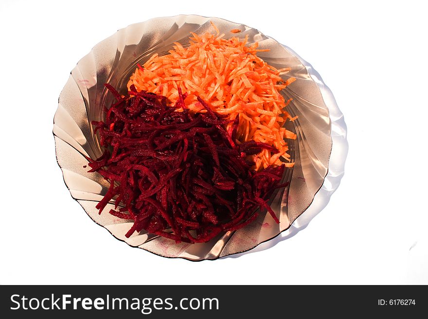 Platel of freshly cut vegetables isolated on a white background. Platel of freshly cut vegetables isolated on a white background