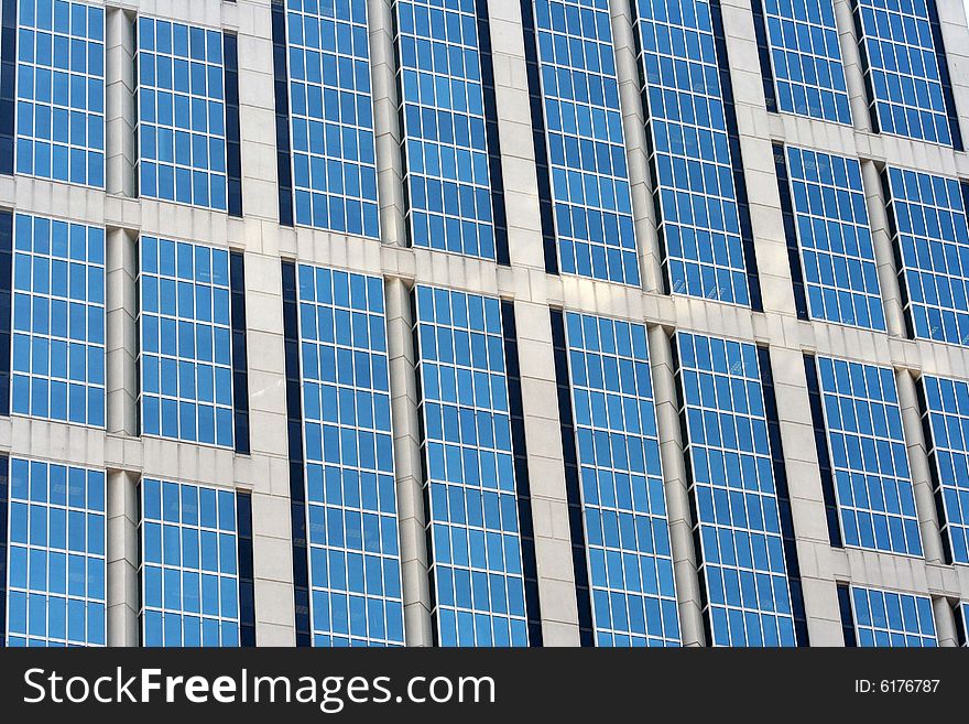 Close-up of a glass building with blue tint