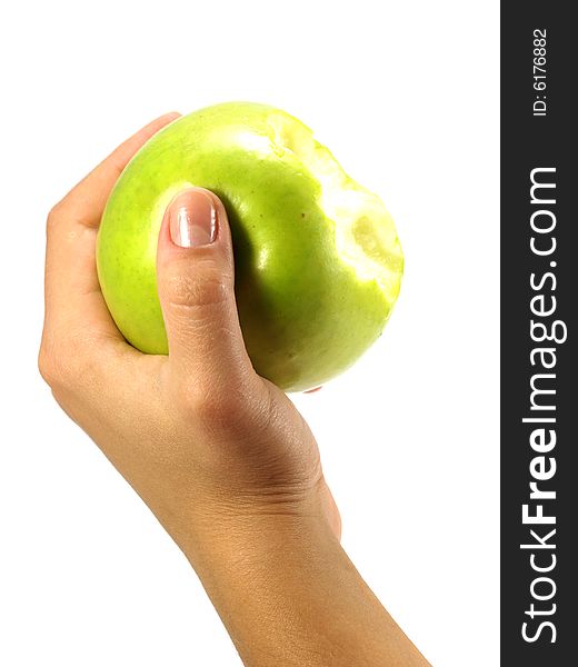 Green apple in a female hand isolated on a white background