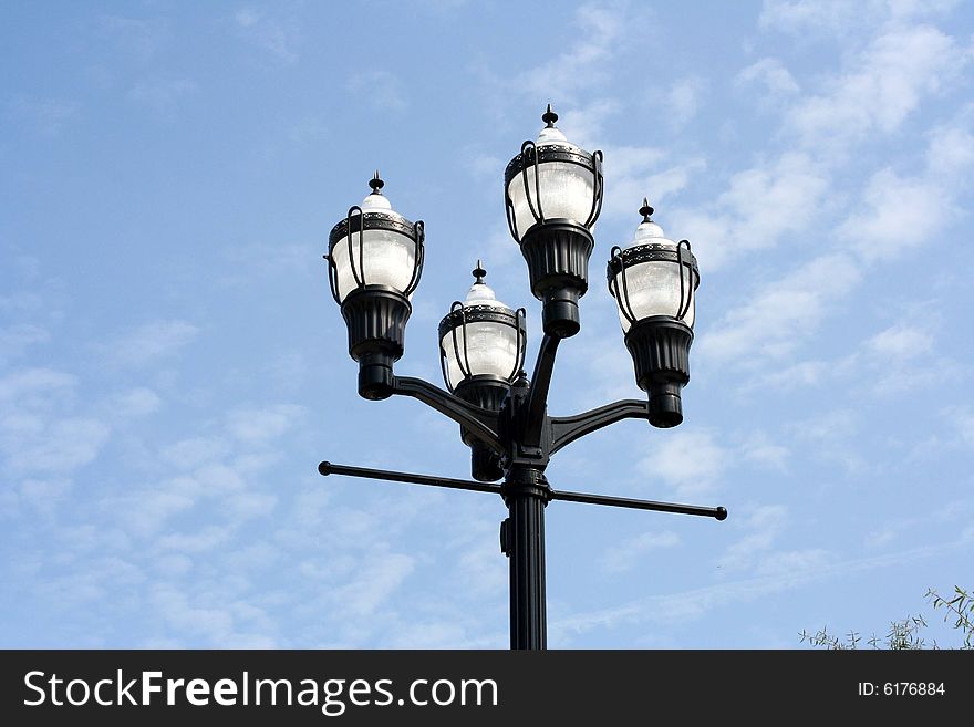 Street lamps with a bright blue sky background. Street lamps with a bright blue sky background