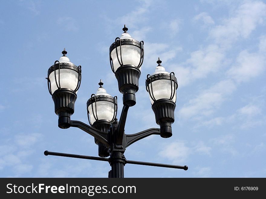 Street lamps with a bright blue sky background. Street lamps with a bright blue sky background