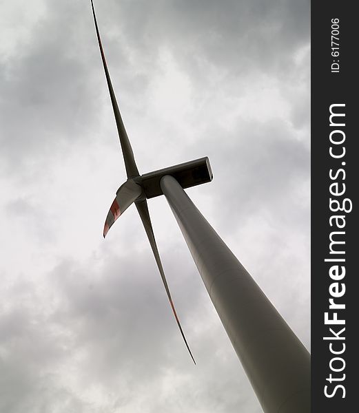 Windmill from frog perspective and clouds in the background