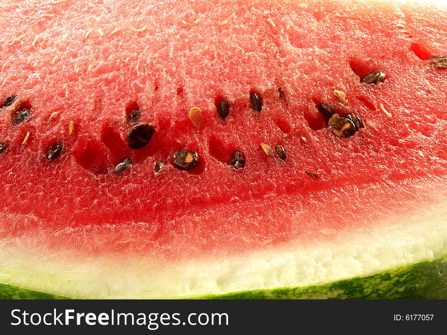 Red juicy water-melon with black and brown spots