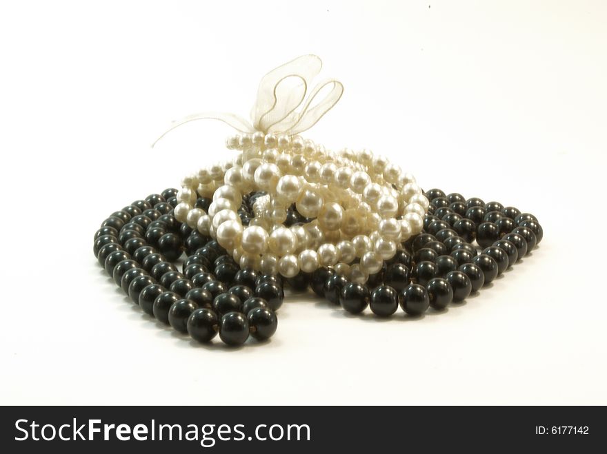 Black beads and white braclet on white background