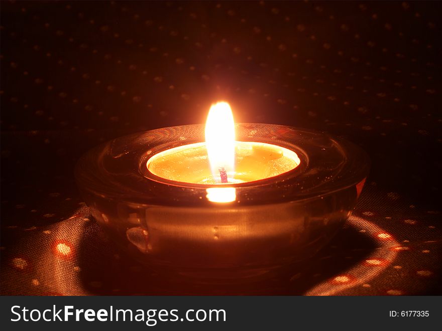 The candle on the black background. The candle on the black background