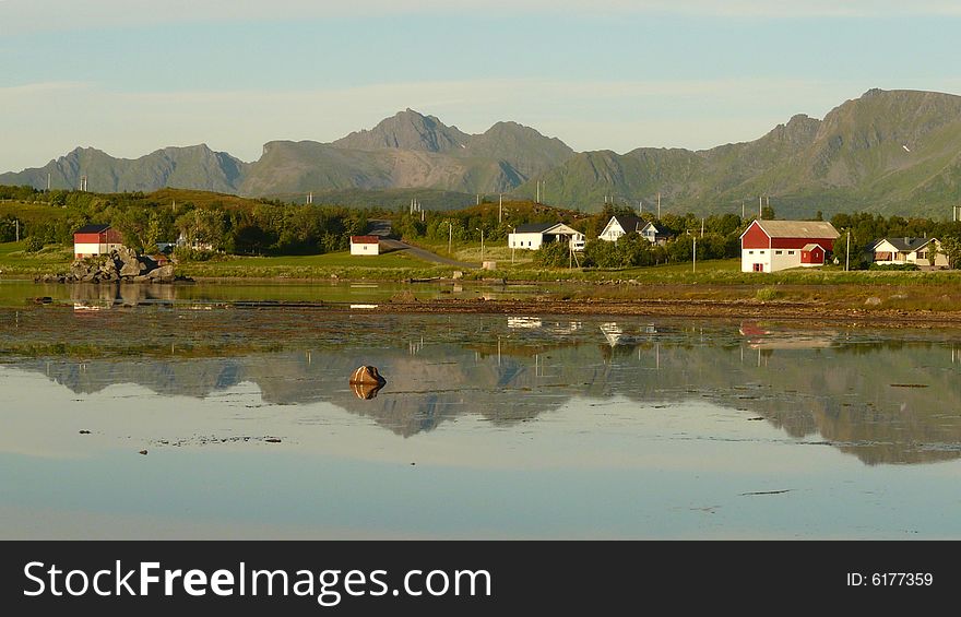 Small village mirroring at midnight, Lofoten islands, Norwegian arctic circle. Small village mirroring at midnight, Lofoten islands, Norwegian arctic circle