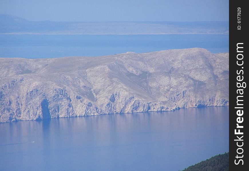 Croatia - view from the Velebit Mountain (Vratnik Pass) to the Adriatic Sea and Kvarner Bay - islands of Krk and Cres in the background. Croatia - view from the Velebit Mountain (Vratnik Pass) to the Adriatic Sea and Kvarner Bay - islands of Krk and Cres in the background