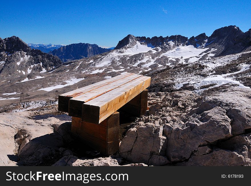 A bench on the Alps, in a sunny summer afternoon. A bench on the Alps, in a sunny summer afternoon