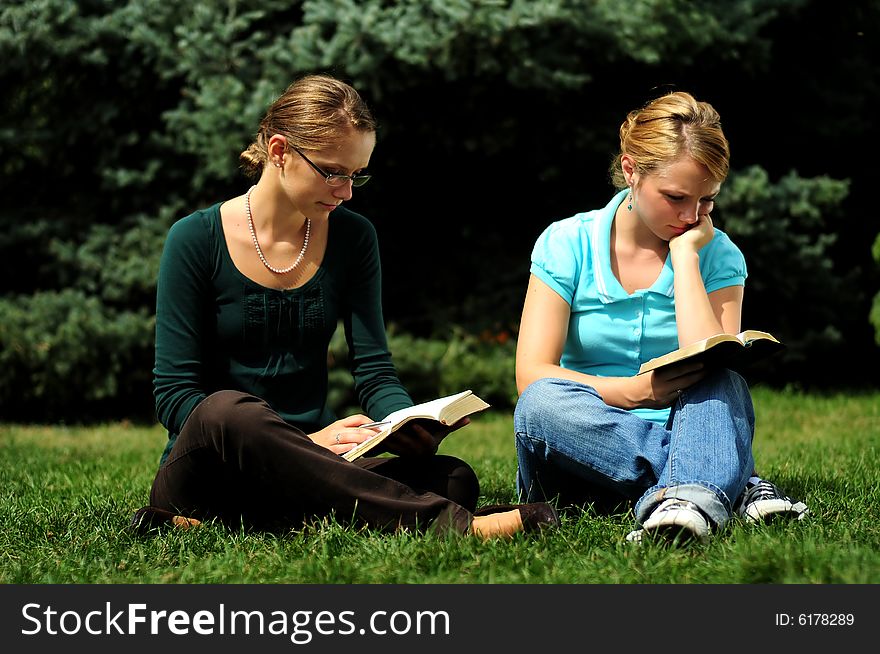 Sisters Reading in a public park. Sisters Reading in a public park