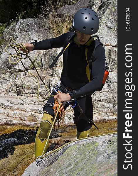 Men prepering for descending waterfall in rappel