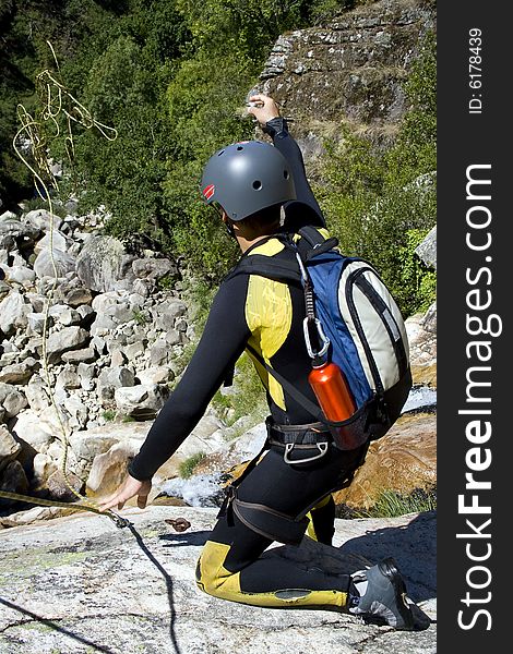 Men prepering for descending waterfall in rappel. Men prepering for descending waterfall in rappel