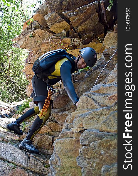 Men climbed rock on canyoning pratice. Men climbed rock on canyoning pratice