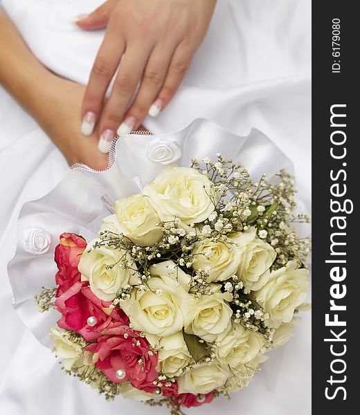 Wedding bouquet of roses holding by bride