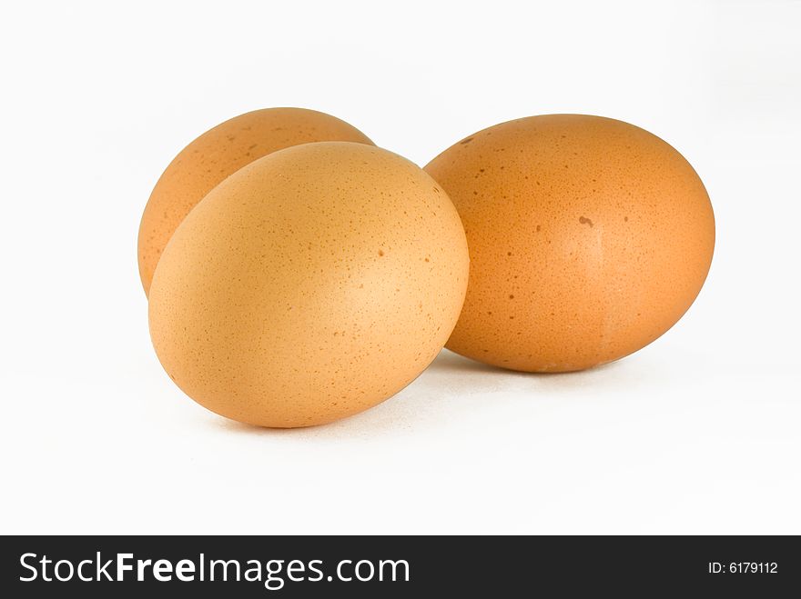 Three chicken eggs on a white background. Three chicken eggs on a white background