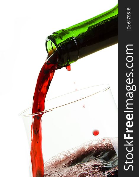 Pouring red wine,isolated on white