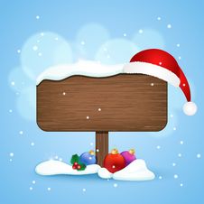 Wooden Sign With Christmas Hat And Baubles In The Snow Royalty Free Stock Photography Wooden Sign With Christmas Hat And Baubles In The Snow Royalty Free Stock Photography