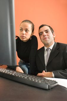 Businessman And Woman Look At Computer - Vertical Stock Photography