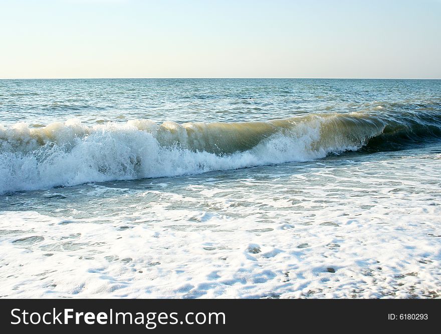 Abstract scene with wave on sea beach under year blue sky