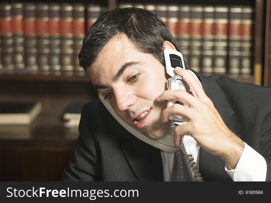 Businessman on cell phone in office. Horizontally framed photo. Businessman on cell phone in office. Horizontally framed photo.