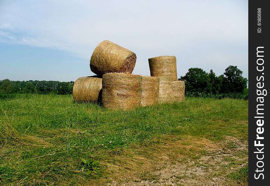 Bales of hay out in a field. Horizontally framed photo. Bales of hay out in a field. Horizontally framed photo.