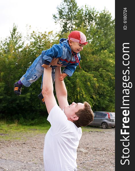 Father and little son playing outdoor. Father and little son playing outdoor