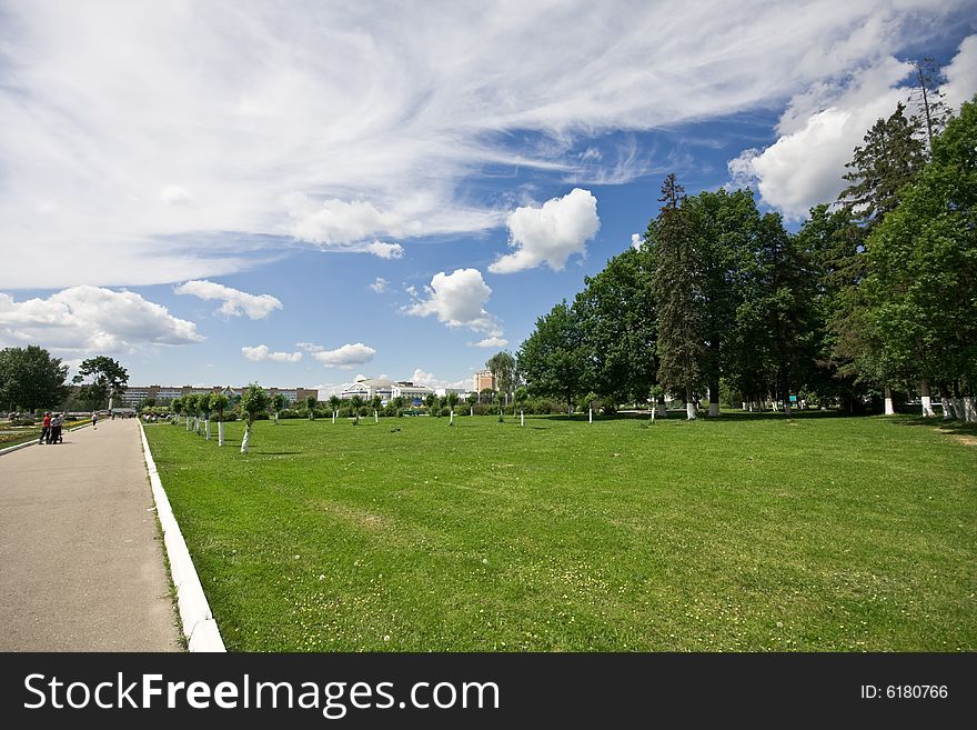 Park landscape - trees, grass and clouds