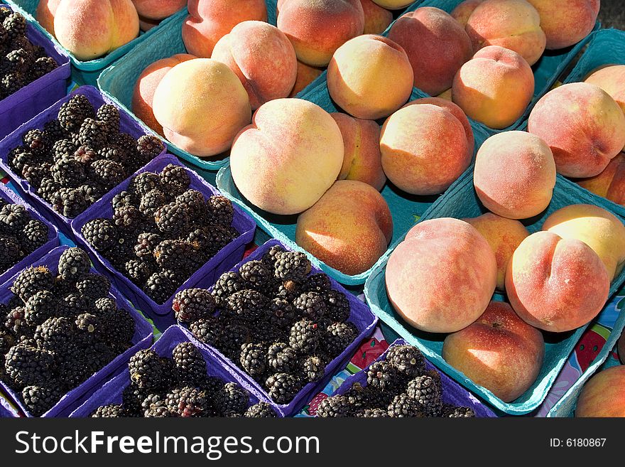 Boxes of peaches and blackberries. Horizontally framed photo. Boxes of peaches and blackberries. Horizontally framed photo.