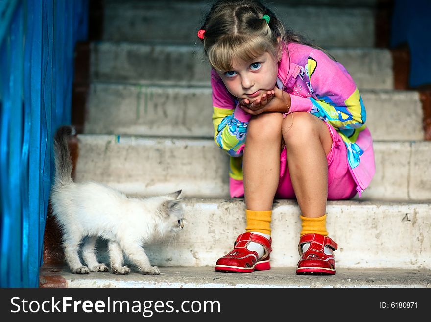 Little girl and cat is sitting on stairs. Little girl and cat is sitting on stairs