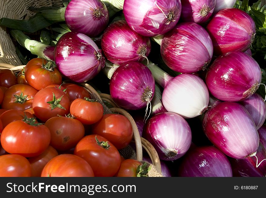 Basket of tomatoes and red onions. Horizontally framed photo. Basket of tomatoes and red onions. Horizontally framed photo.