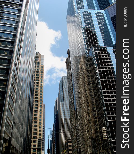 View from below a group of tall buildings. Vertically framed photo. View from below a group of tall buildings. Vertically framed photo.