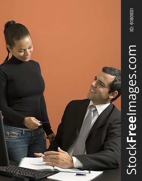 Businessman And Woman In Office - Vertical